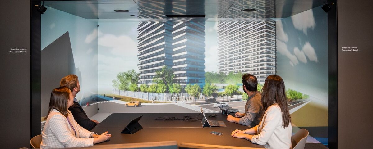 Four people discussing a building project in the Avalon Virtual Reality Room.