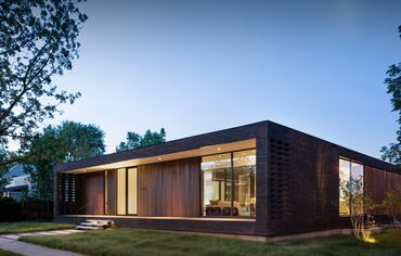 Night time view of American contemporary Brick City House.